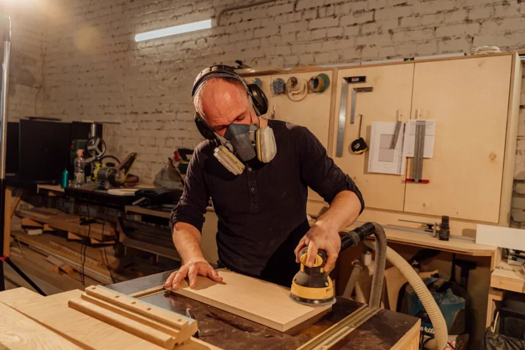 Carpenter in Multan polishing a wooden surface