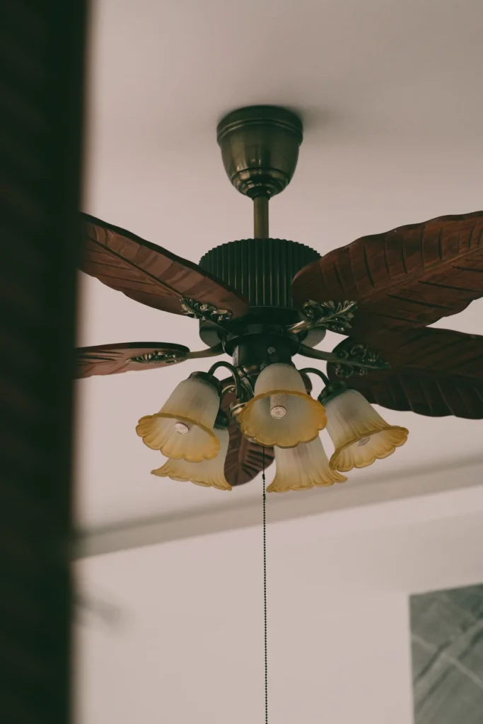 Electrician in Multan installing a ceiling fan