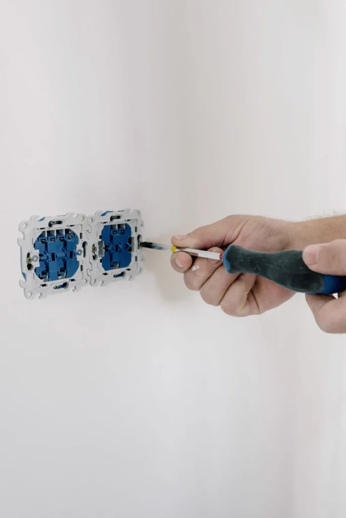 Electrician in Multan repairing a switch